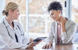 Consulting, neck pain and medical with black woman and doctor for injury, healthcare and physical t